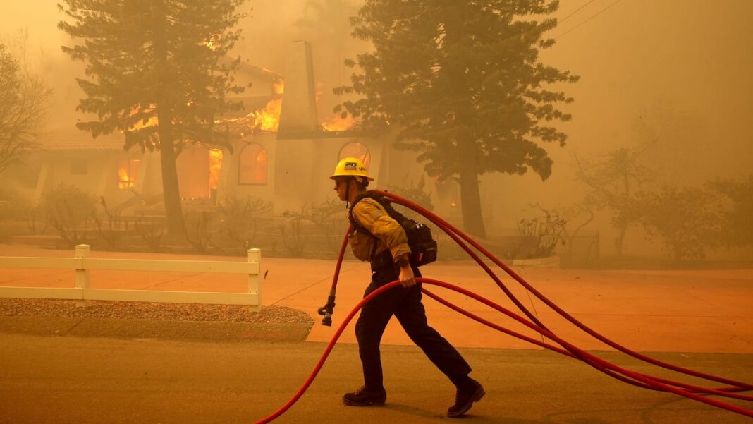 Southern California wildfire moving ‘dangerously fast’ as flames destroy homes