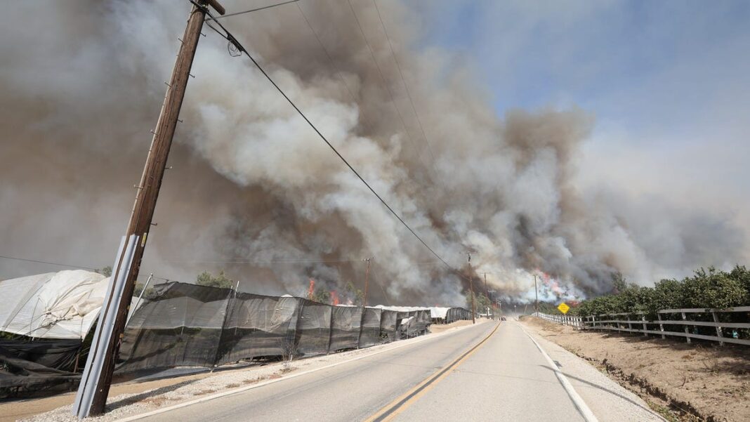 Southern California wildfire rages as it engulfs homes, forces mass evacuations