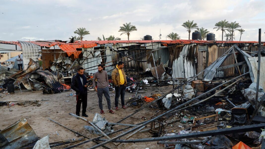 Israel bombs refugee camp, killing 20, as rights group charges ‘genocide’